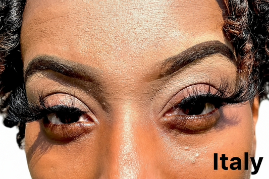 Close-up of a person's eyes with detailed makeup and false eyelashes